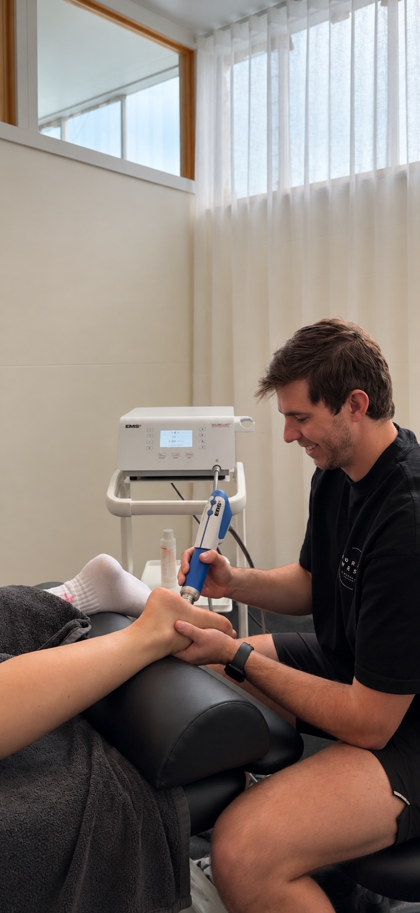 Brayden Stevenson treating a patient’s heel in the clinic